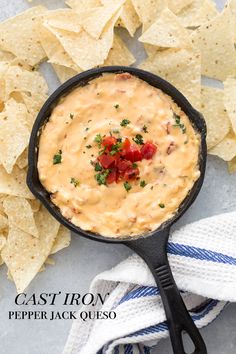 a skillet with tortilla chips and salsa in it