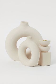 three white vases sitting next to each other