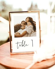 a table with a card that has an image of two people holding each other on it