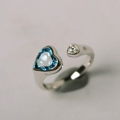 It is real London blue topaz ring, the heart cut topaz is about 8mm*8mm, weight about 2.33 carats. The basic metal is sterling silver and plated with rhodium. To change the metal to a solid gold (white/rose) or platinum is also available, please ask for a quotation if you want. You can also go to my shop Home for more elegant rings: https://www.etsy.com/shop/godjewelry?ref=hdr_shop_menu Topaz is November birthstone. More topaz rings: https://www.etsy.com/shop/godjewelry?ref=hdr_shop_menu&sec Silver Heart Rainbow Topaz Rings, Silver Heart Rainbow Topaz Heart Rings, Sterling Silver Open Heart Ring For Proposal, Sterling Silver Heart Cut Topaz Promise Ring, Silver Heart Cut Sterling Silver Topaz Ring, Silver Sterling Silver Heart Cut Topaz Ring, Silver Sterling Silver Topaz Ring With Heart Cut, Silver Heart Cut Topaz Ring In Sterling Silver, Sterling Silver Heart Ring With Birthstone