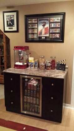 a coffee bar in the corner of a room with pictures on the wall above it