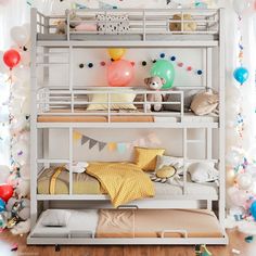 two bunk beds in a room with balloons and streamers