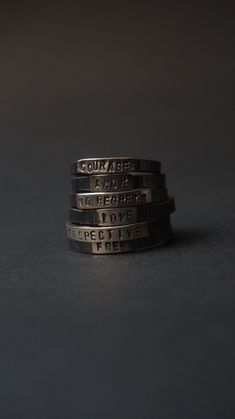 "This ring is simple, small, but meaningful.  I have lost count of how many of these I made, people buy them as reminders with words like \"Patience\", as mantras and meditation pieces \"Breath\", \"Here now\", with a name of loved ones, kids, grandparents, etc.  These make for a very special small gift, my sister chose \"Peace\", I gave one to a friend with \"Persevere\" after he told me he struggled with a project, memory of a trip to Costa Rica for a friend was \"Pura vida\". What we choose to wear really can carry power, what is your word? Which one you'd like to give to someone else? Each ring is made to order in the size you choose, and each letter is a single hammer blow, stamped in place, the font is like a typewriter and they are small 1.5mm each, so it is a subtle piece. * Materi Silver Everyday Stackable Rings, Silver Stackable Promise Rings, Black Hand Stamped Jewelry For Everyday, Meaningful Promise Stackable Rings, Stackable Promise Rings With Meaningful Style, Meaningful Stackable Engraved Sterling Silver Ring, Meaningful Stamped Engraved Promise Ring, Meaningful Silver Stackable Rings, Meaningful Stackable Sterling Silver Rings