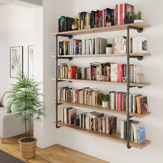 a bookshelf filled with lots of books next to a couch