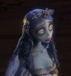 a creepy doll with long hair and makeup