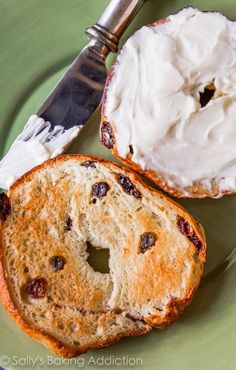 a piece of bread with cream cheese and raisins on it next to a knife