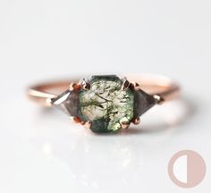 Moss agate & salt pepper diamond engagement ring with a simple three-stone geometric setting. Rustic hexagon or octagon-cut green gemstone ring with accent grey diamond triangles, pictured here in rose gold. The prices listed are for the moss agate ring only. Please see the set here: https://www.etsy.com/listing/965328699/ And the plain curved band here: https://www.etsy.com/listing/654582518/ We are the original jewelry designers to use moss agate and create geometric moss agate one-of-a-kind j Engagement Rings Moss, Engagement Rings Moss Agate, Agate Wedding Ring, Salt Pepper Diamond, Pepper Diamond Ring, Green Gemstone Ring, Engagement Ring Ideas, Agate Engagement Ring, Moss Agate Ring