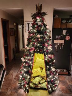 a decorated christmas tree with presents in it