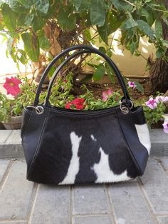 Indulge in the sophistication of our Cowhide Leather Top Handle Purse, a luxurious accessory for the stylish woman. Crafted from premium black leather, this shoulder bag exudes elegance and exclusivity for Women, handcrafted for a level of sophistication and quality you won't find anywhere else. Front and back real cowhide Genuine leather use in Bottom, sides ,top handles and shoulder straps Spacious and durable and unique in its print Color : Black Perfect for your daily handbag and laptop bag Canvas lining inside Zipper closure High quality smooth zippers Customization is optional. If you need the bag to be customized, Send us your name or initials with your order.Dimensions: ( inches)12(L) x 7(H) x 6(W) Each cowhide is unique in its print and texture so the bag you will receive will be Luxury Black Hobo Bag For Formal Occasions, Elegant Black Bags With Leather Lining, Formal Leather Handheld Hobo Bag, Formal Handheld Shoulder Bag With Leather Lining, Luxury Black Hobo Bag With Leather Lining, Black Handheld Hobo Bag For Formal Occasions, Elegant Black Hobo Bag, Formal Black Shoulder Bag With Leather Handles, Canvas Laptop Bag