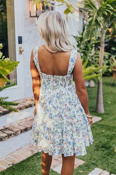 - This sweet dress is perfect for a stylish look! - Fully lined material with a colorful floral print - A v-cut neckline - Wide straps - A bodice with a front tie feature, a cut-out detail, a smocked back, and back zip closure - A flowy yet flattering silhouette that ends in a rounded hemline with ruffle detail V-neck Sundress With Ditsy Floral Print For Day Out, Summer V-neck Sundress With Ditsy Floral Print, Square Neck Ditsy Floral Dress For Beach, V-neck Floral Print Sundress For Day Out, Summer Floral Dress With Tie Back, Floral Print V-neck Sundress For Brunch, Summer Floral Dress With Tie Back For Brunch, Summer Floral Dress With Square Neck For Day Out, V-neck Floral Print Sundress For Brunch