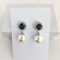 Simple and classic!! I've created these elegant black cubic zirconia and Swarovski pearl bridal earrings in rhodium plated brass setting. Earrings feature large 12mm Swarovski pearls that dangle from brilliant cut black cubic zirconia with halo setting ear stud. Halo setting gives a brilliantly beautiful effect. Total length of the earrings is 2.9 cms. For a matching necklace click: https://www.etsy.com/listing/252977878/pearl-bridal-necklace-pearl-cubic?ref=shop_home_active_9 For matching brace Black Pearl Drop Earrings For Formal Occasions, Black Dangle Pearl Earrings For Formal Occasions, Black Pearl Drop Earrings For Formal Events, Elegant Black Bridal Earrings For Formal Occasion, Classic Black Earrings For Wedding, Black Round Earrings For Wedding, Elegant Black Bridal Earrings As Gift, Black Pearl Drop Earrings For Evening, Classic Black Wedding Earrings