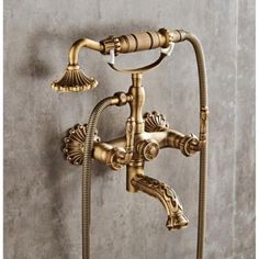 an antique brass faucet with two hoses attached to the side of it