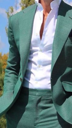 Man is wearing a green two piece suit with a white collard shirt. Green Suit Aesthetic Men, Elegant Green Suit With Notch Lapel, Luxury Green Unstitched Men's Suit, Green Notch Lapel Three-piece Suit For Party, Luxury Green Single-breasted Suit, Green Single-breasted Suit With Lapel Collar, Men Suit Fashion, Turquoise Suit, Green Suit Men