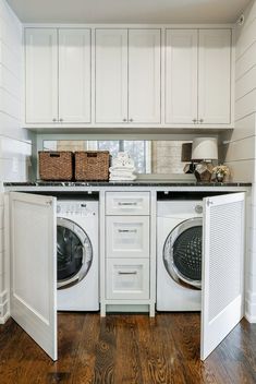 a white washer and dryer sitting inside of a laundry room next to each other