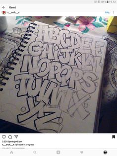 an open notebook with graffiti written on it and the word's name in black ink