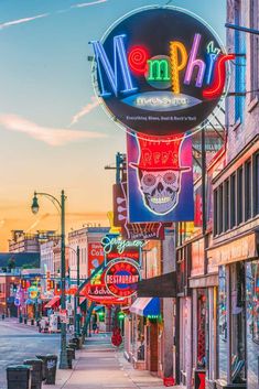 neon signs on the side of buildings in an urban area