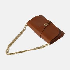 Meet our newest crossbody, The Pennington! This timeless design embodies class, organization, and ease. Made from a rich vegetable-tanned leather, it holds a structured shape for an elevated look. This multifunctional wallet is large enough to comfortably fit your phone and keys. Wear it as a crossbody with the Leather Crossbody Strap it comes with, The Chain Strap (sold separately), or as a clutch for a night out. The Pennington is made in León which has a rich history in leather-working and ta Luxury Leather Wallet On Chain For Business, Luxury Leather Business Wallet On Chain, Luxury Leather Wallet With Detachable Strap, Classic Brown Rectangular Wallet On Chain, Versatile Leather Clutch With Smooth Grain, Luxury Leather Wallet On Chain With Adjustable Strap, Classic Formal Wallet On Chain With Adjustable Strap, Modern Formal Saddle Bag With Smooth Grain, Brown Leather Wallet On Chain Crossbody