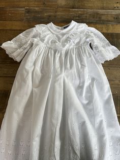 A beautiful vintage baby's Christening robe made by Sturgenegger, Switzerland.  100% Baumwolle, high quality cotton. It has a small collar, lace and appliqué puffed sleeves.  It has a cotton lining. Three buttons at the back.  Lace and appliqué front and hem.  Length 81cm Chest 25 cm  It is bright white and is in lovely condition. Long Sleeve Baptism Dress With Ruffles, Fitted Long Sleeve Baptism Dress For Spring, Long Sleeve Baptism Dress With Ruffles For First Communion, Spring Baptism Dress With Lace Collar, Fitted Baptism Dress With Lace Work For Spring, Fitted Broderie Anglaise Baptism Dress For Spring, Fitted Cotton Baptism Dress With Ruffles, Fitted White Cotton Baptism Dress, White Fitted Cotton Baptism Dress