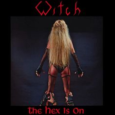 a woman with long blonde hair and leather gloves is standing in front of a sign that says, witch the hex is on