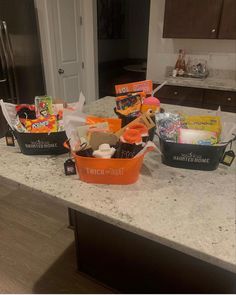 the kitchen counter is covered with baskets and other items that are sitting on top of it