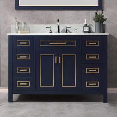 a bathroom vanity with a large mirror above it