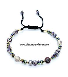 This beautifully handmade bracelet is made of medium (4mm) crystal beads, two purple agate beads, evil eye beads and gold colored tiny beads. The bracelet is made with memory wire and nylon string with a sliding knot to adjust to the majority of the wrist sizes. These are a great accessory for everyday wear. Esta hermosa pulsera esta hecha a mano de cuentas medianas de cristal (4 mm), cuentas agata y cuentas de ojo turco con cuentas pequenas de color dorado. La pulsera está hecha con alambre de Adjustable Agate Crystal Bracelet With 8mm Beads, Adjustable Agate Crystal Bracelet With Round Beads, Elegant Beaded Evil Eye Bracelet Gift, Evil Eye Bracelet With Gemstone Beads As Gift, Adjustable Agate Jewelry With Spacer Beads, Evil Eye Bracelet With Round Gemstone Beads, Gift Evil Eye Bracelet With Gemstone Beads, Healing Beaded Evil Eye Bracelet With Round Beads, Elegant Evil Eye Bracelet With Round Beads