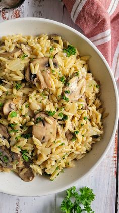 a white bowl filled with pasta and mushrooms