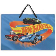 a hot wheels sign hanging on a wall