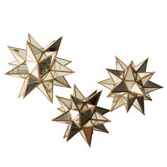 three star shaped mirrors are hanging on the wall