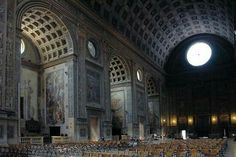 rows of chairs in an ornately decorated building