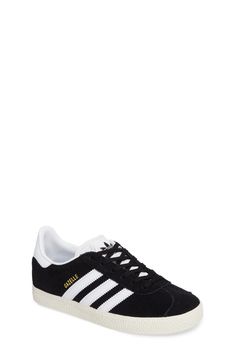 Initially designed as a training shoe for top athletes in 1991, the iconic adidas Gazelle sneaker has been refreshed with a sleek, narrower silhouette but retains the classic 3-Stripes and heel tab of the original. Lace-up style Removable OrthoLite® insole Leather and synthetic upper/textile and synthetic lining/rubber sole Imported Kids' Shoes Adidas Low-top Basketball Shoes With Gum Sole, Classic Adidas High-top Sneakers For Sports, Classic Black Adidas Skate Shoes, Sporty Black Sneakers With Gum Sole, Classic Black Skate Shoes With Three Stripes, Classic Lace-up Skate Shoes For Sports, Classic Black Sneakers With Three Stripes, Adidas High-top Sneakers For Tennis, Adidas High-top Tennis Sneakers