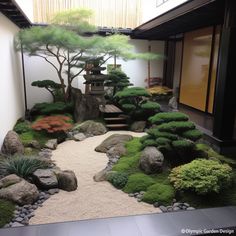 a japanese garden with rocks, grass and trees on the ground in front of a building