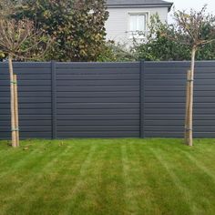 a fenced in yard with grass and trees