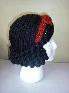 a crocheted hat on top of a white mannequin head