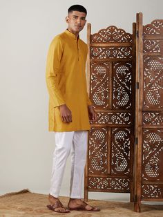 Vastramay Men's Mustard Cotton Kurta With White Pant Set Elevate your ethnic wardrobe with this stylish kurta pajama set from Vastramay. This combination of a vibrant mustard kurta and classic white pants is perfect for both festive occasions and casual gatherings. Key Features: Mustard colored, above-the-knee length kurta Mandarin collar and button placket Long sleeves with side slits Pockets for added functionality Comfortable white pants with an elasticized waistband for a relaxed fit Made fr Fitted Cotton Churidar For Puja, Festive Traditional Kurta With Relaxed Fit, Traditional Relaxed Fit Kurta For Festive Occasions, Traditional Long Sleeve Kurta With Relaxed Fit, Yellow Cotton Churidar For Festivals, Long Sleeve Cotton Churidar For Puja, Yellow Cotton Churidar With Straight Kurta, Mustard Straight Kurta For Diwali, Fitted Cotton Kurta For Puja