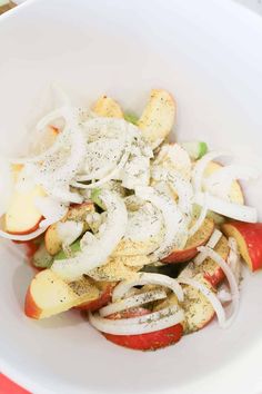 an apple and onion salad in a white bowl