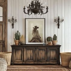 a living room filled with furniture and a chandelier hanging from the ceiling next to a painting