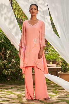 Peach tunic with sequin and cutdana embroidery. Paired with a flared pant. - Aza Fashions Festive Peach Cutdana Sets, Festive Peach Fitted Kurta, Fitted Ankle-length Kurta With Cutdana, Festive Semi-stitched Peach Sharara, Designer Semi-stitched Peach Kurta, Peach Crepes, Cutdana Embroidery, Woven Wrap, Tunic Pattern