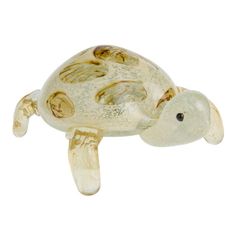 a glass figurine of a turtle on a white background