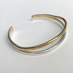 Hammered and formed two layer cuff. Comes in three options:-Brass-Sterling Silver-Brass and Sterling silver*a good way to measure is cutting a slice of paper or string to a size ( ex. med. 5.5’’) and wrap around wrist. Their should be about 3/4 to a 1 inch in space between each end. This leaves room for your own adjustment. Wrap Around, 1 Inch, Silver Bracelet, Bangles, Cuff, Brass, Sterling Silver, Silver