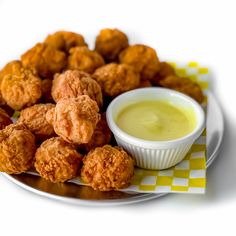 some fried food on a plate with dipping sauce