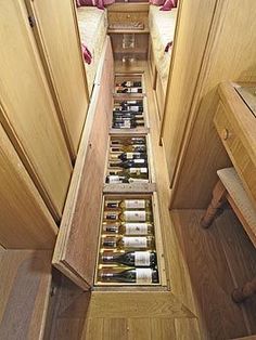 the narrow hallway is filled with bottles of wine