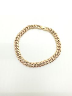 "Gold tone curb link bracelet with gold over clasp. Chain measures approximately 8\"." Metal Cuban Link Bracelet With Solid Construction, Gold-tone Chain Link Bracelets, Metal Cuban Link Bracelet With Curb Chain, Cuban Link Bracelet With Curb Chain In Metal, Metal Cuban Link Bracelet, Cuban Link Chain Bracelet With Solid Link Construction, Classic Cuban Link Bracelet With Chunky Chain, Gold Chain Cuban Link Metal Bracelet, Gold-tone Chunky Chain Bracelet