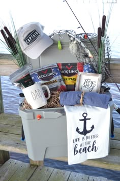 a cooler filled with various items sitting on top of a wooden dock