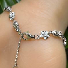 We’ve combined our two most requested charms onto one bracelet! Like mini ornaments, Petite Pineapples and Plumeria Flowers with cubic zirconia centers, alternate along the chain. You’ll want to wear this bracelet all the time as a reminder of Hawaii and it’s adjustable! Just close the clasp where it fits around your wrist. Available in Gold Plated, Sterling Silver and Rose Gold. .925 Sterling Silver Available in Gold Plated, Sterling Silver and Rose Gold. Adjusts from 7" to 8.5" Silver Cubic Zirconia Bracelets As Gift For Her, Adjustable Chain Dangle Bracelet, Dainty Silver Bracelet With Extender, Silver Dainty Bracelet With Extender, Stainless Steel Charm Bracelet With Lobster Clasp, Adjustable White Gold Charm Bracelets, Adjustable Sterling Silver Bracelet With Flower Charm, Adjustable Sterling Silver Bracelets With Flower Charm, Sterling Silver Dangle Bracelets With Adjustable Chain