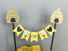 there is a cake on the table with yellow paper and bunting flags in front of it