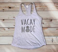 Ladies Vacation Mode (VACAY MODE) Tank Top - Perfect gift for her before she travels Our graphic tanks are very soft and lightweight Free Shipping on all orders $35+ **PINEAPPLE VACATION MODE TANK DETAILS** Model: N1533 Cotton: 60% Weight: 4 Oz Sizes: XS, S, M, L, XL, 2XL Features Tear-away label Self-fabric binding on neck and armholes Fabric laundered for reduced shrinkage 30 singles 4 oz. 60% combed ring spun cotton/40% polyester lightweight jersey Ladies fitted Racerback Tank **CUSTOM** *If Beach Vacation Tank Top, Printed Tank Top For Vacation And Beach Season, Tropical Tank Top For Beach Season, Fun Beach Season Tank Top For Vacation, Beach Season Vacation Tank Top, Funny Travel, Sweatshirts Quotes, Vacay Mode, Travel Shirt