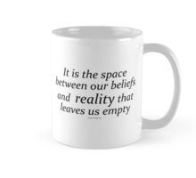 a white coffee mug with the quote it is the space between our beliefs and reality that leaves us empty