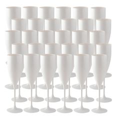 white wine goblets are lined up in rows