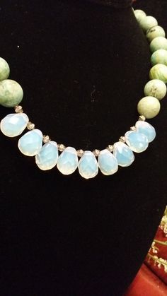 "This is a gorgeous, one of a kind, statement necklace designed and hand crafted personally by Petronella Greer. It's a 1 strand design, made of a light turquoise and opalite that turns colors. The length of the necklace is 18\". The clasp is high quality. It's an exquisite and unique piece of jewelry that no one else will have but you! Also, comes in very nice packaging!" Turquoise Teardrop Faceted Beads Jewelry, Turquoise Faceted Amazonite Jewelry, Faceted Turquoise Amazonite Jewelry, Adjustable Faceted Turquoise Necklace, Handmade Turquoise Chrysoprase Necklaces, Turquoise Teardrop Necklace With Faceted Beads, Turquoise Chalcedony Necklace With Natural Stones, Bohemian Turquoise Chalcedony Necklace, Turquoise Chrysoprase Gemstone Bead Necklaces